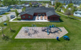 kids playground and community clubhouse with picnic tables