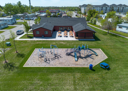 kids playground and community clubhouse with picnic tables