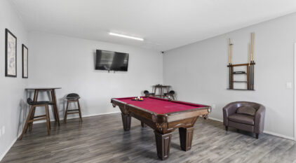 billards room with pool table and table and chairs
